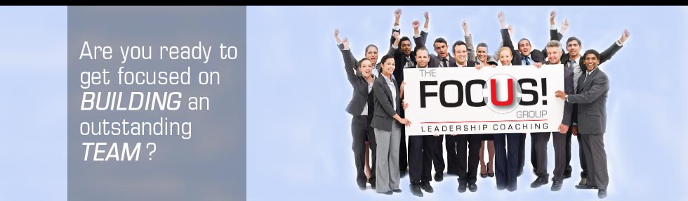A group of business people holding a sign.